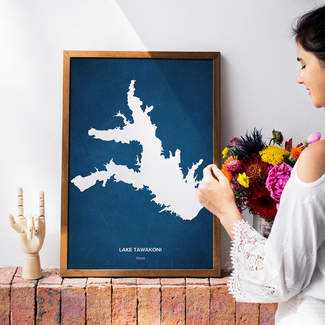 an apartment decorated with flowers and a Lake Tawakoni map poster.